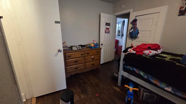 a bed room with a bed mirror and a tv