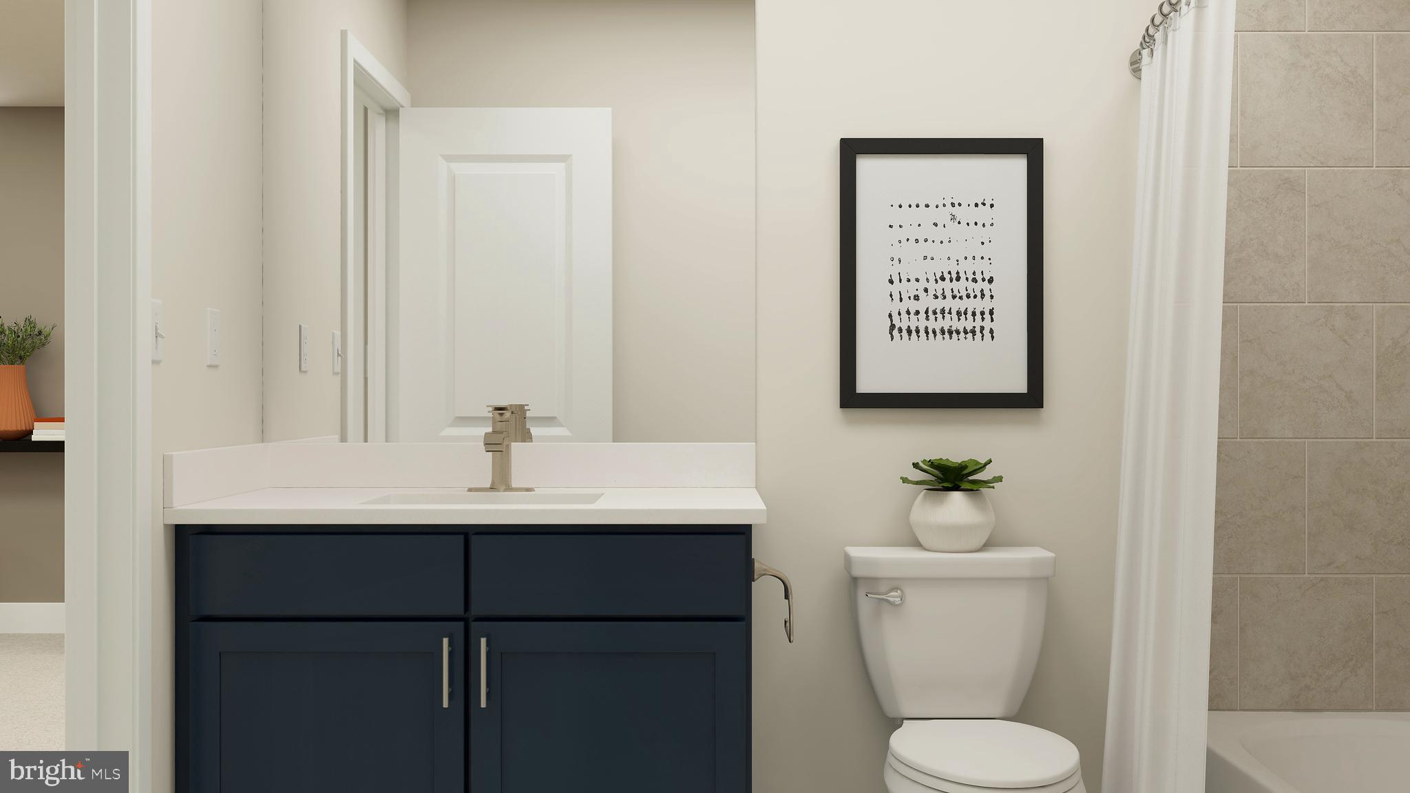 17043 Gathering Street Boyds, MD 20841 - Photo 19 of 29 a bathroom with a toilet a sink and mirror