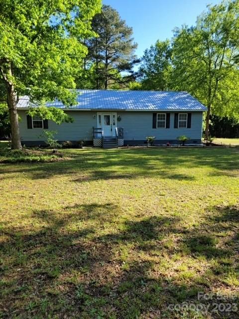 8705 Simpson Road Waxhaw, NC 28173 - Photo 1 of 46 a view of a house with a yard