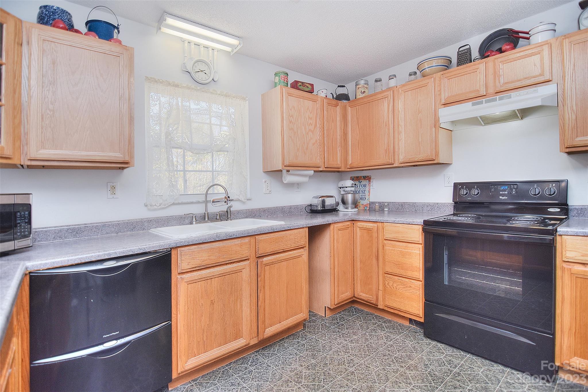 8705 Simpson Road Waxhaw, NC 28173 - Photo 15 of 46 a kitchen with stainless steel appliances granite countertop a sink stove and cabinets