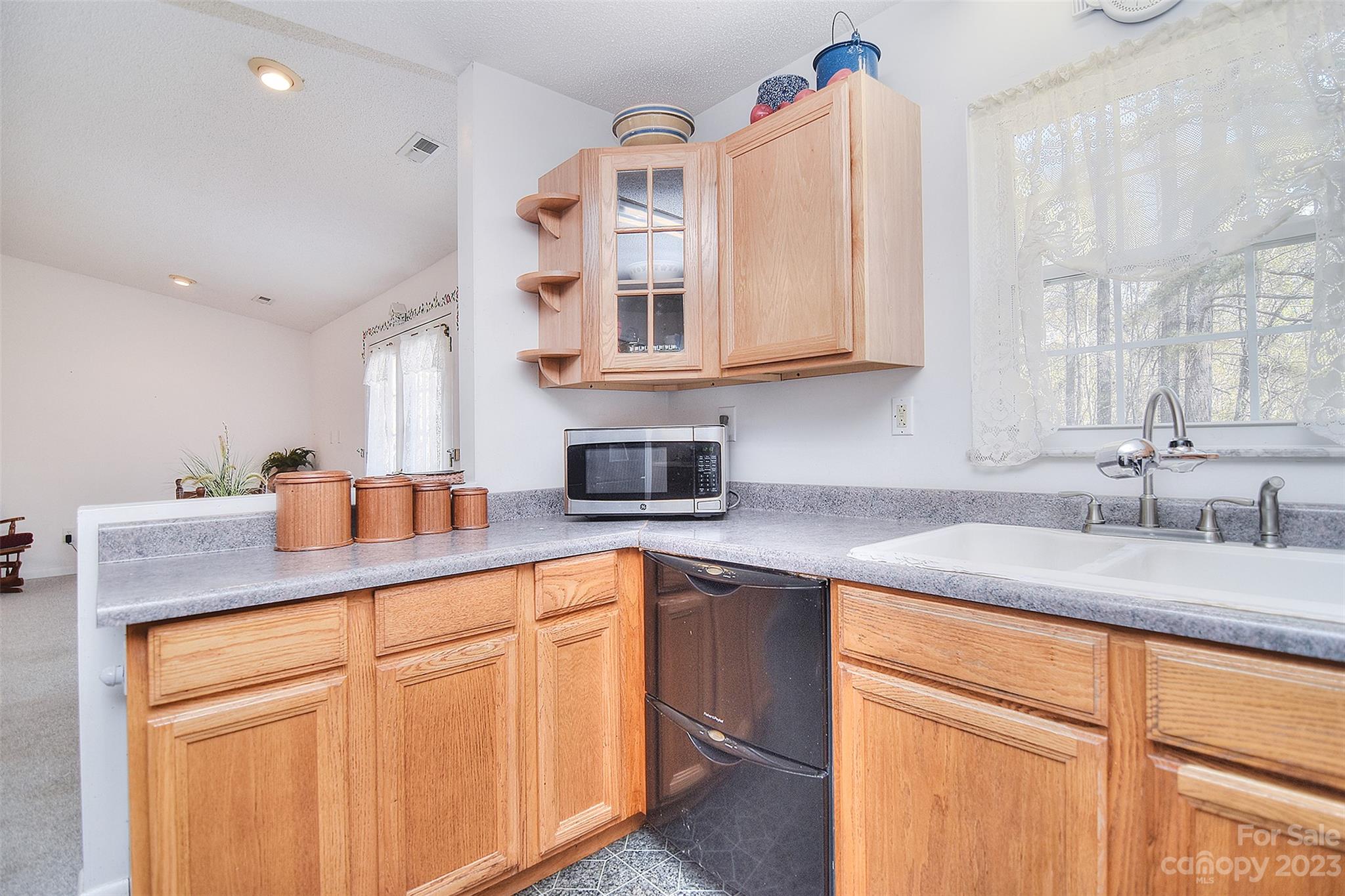 8705 Simpson Road Waxhaw, NC 28173 - Photo 16 of 46 a kitchen with granite countertop a sink stainless steel appliances and cabinets