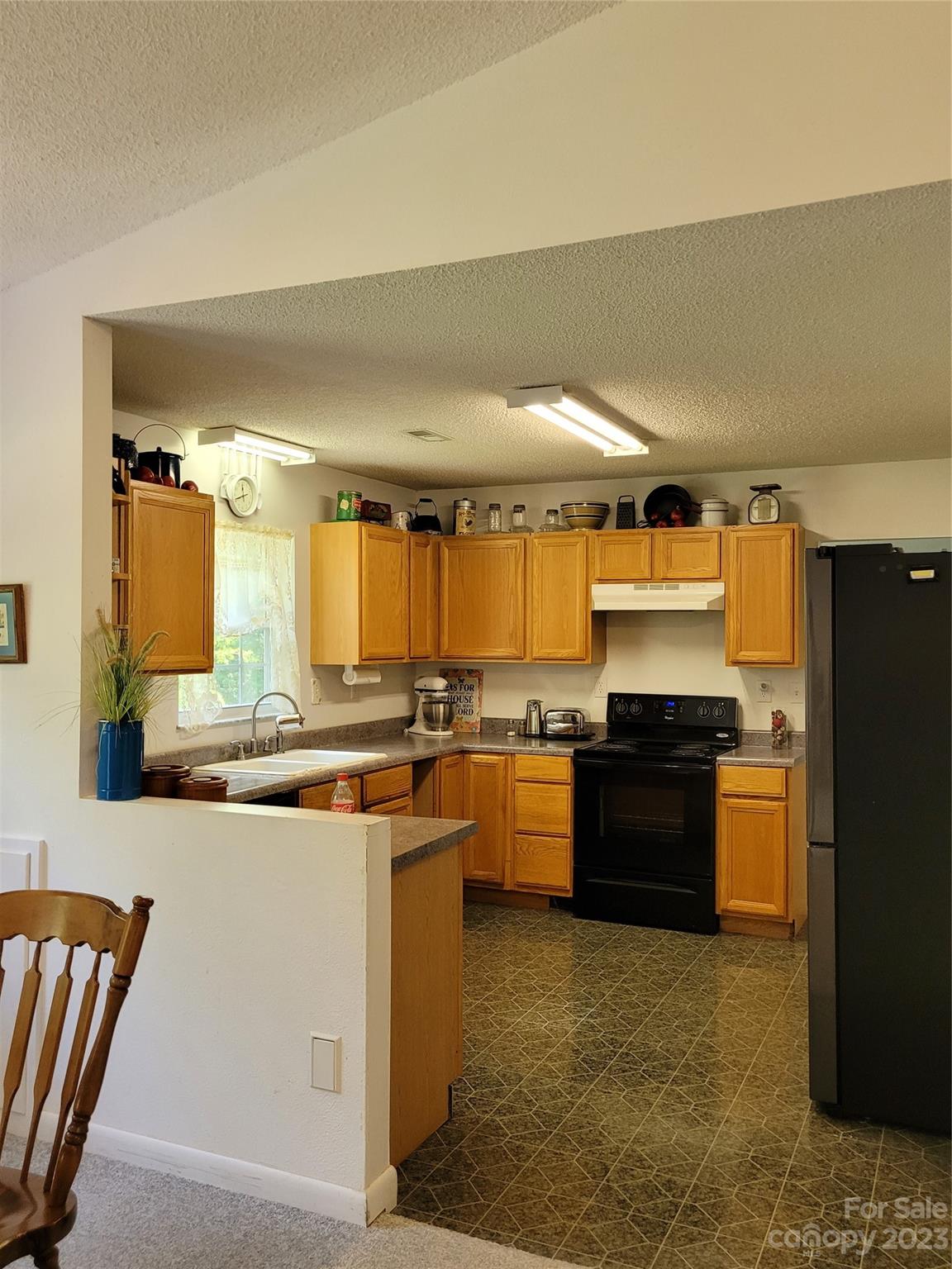 8705 Simpson Road Waxhaw, NC 28173 - Photo 17 of 46 a kitchen with stainless steel appliances granite countertop a refrigerator a stove and a sink