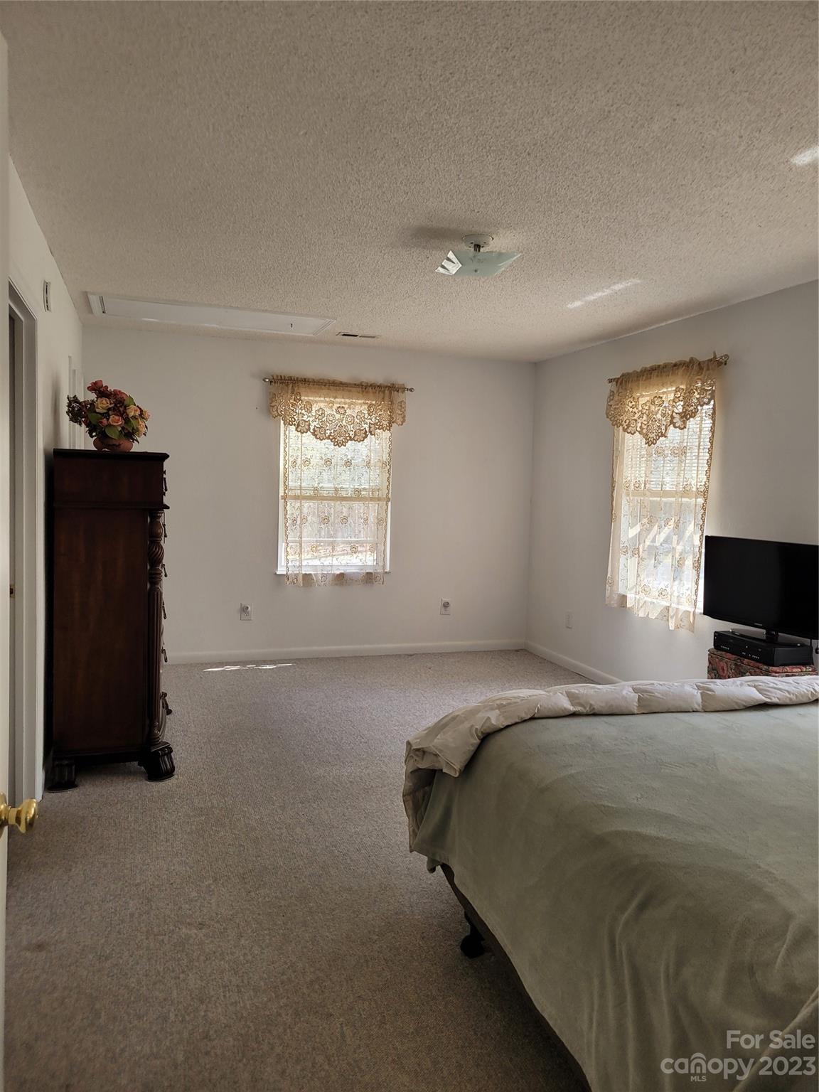 8705 Simpson Road Waxhaw, NC 28173 - Photo 21 of 46 a bed sitting in a bedroom next to a window