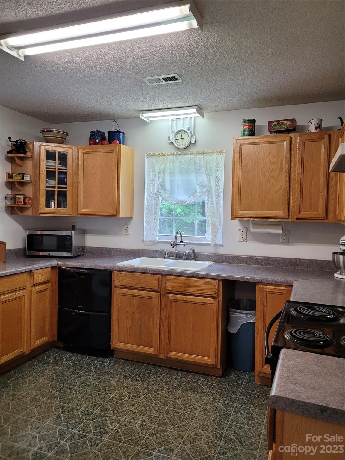 8705 Simpson Road Waxhaw, NC 28173 - Photo 22 of 46 a kitchen with stainless steel appliances granite countertop a sink stove and cabinets