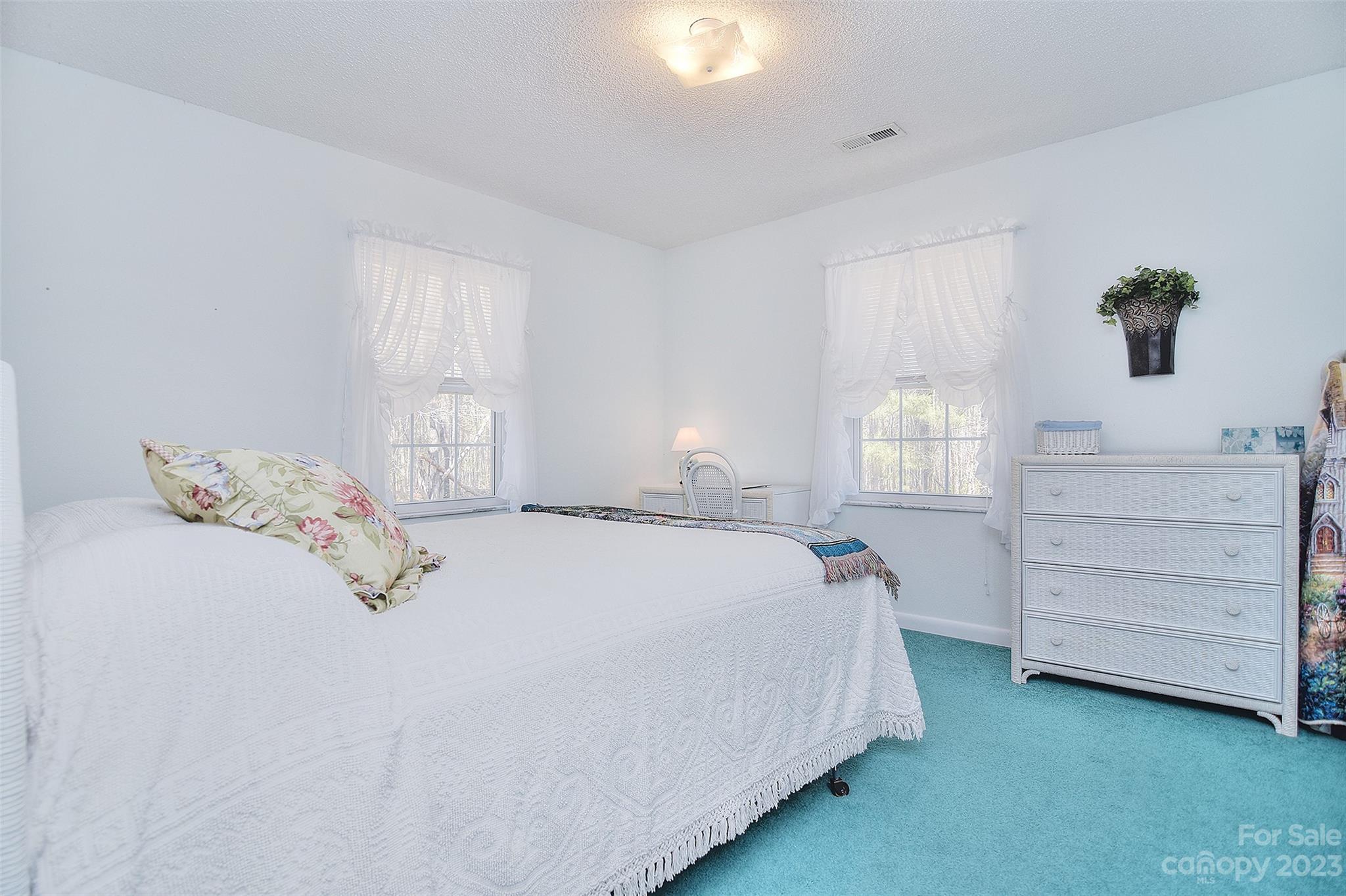 8705 Simpson Road Waxhaw, NC 28173 - Photo 27 of 46 a bedroom with a bed a dresser and window
