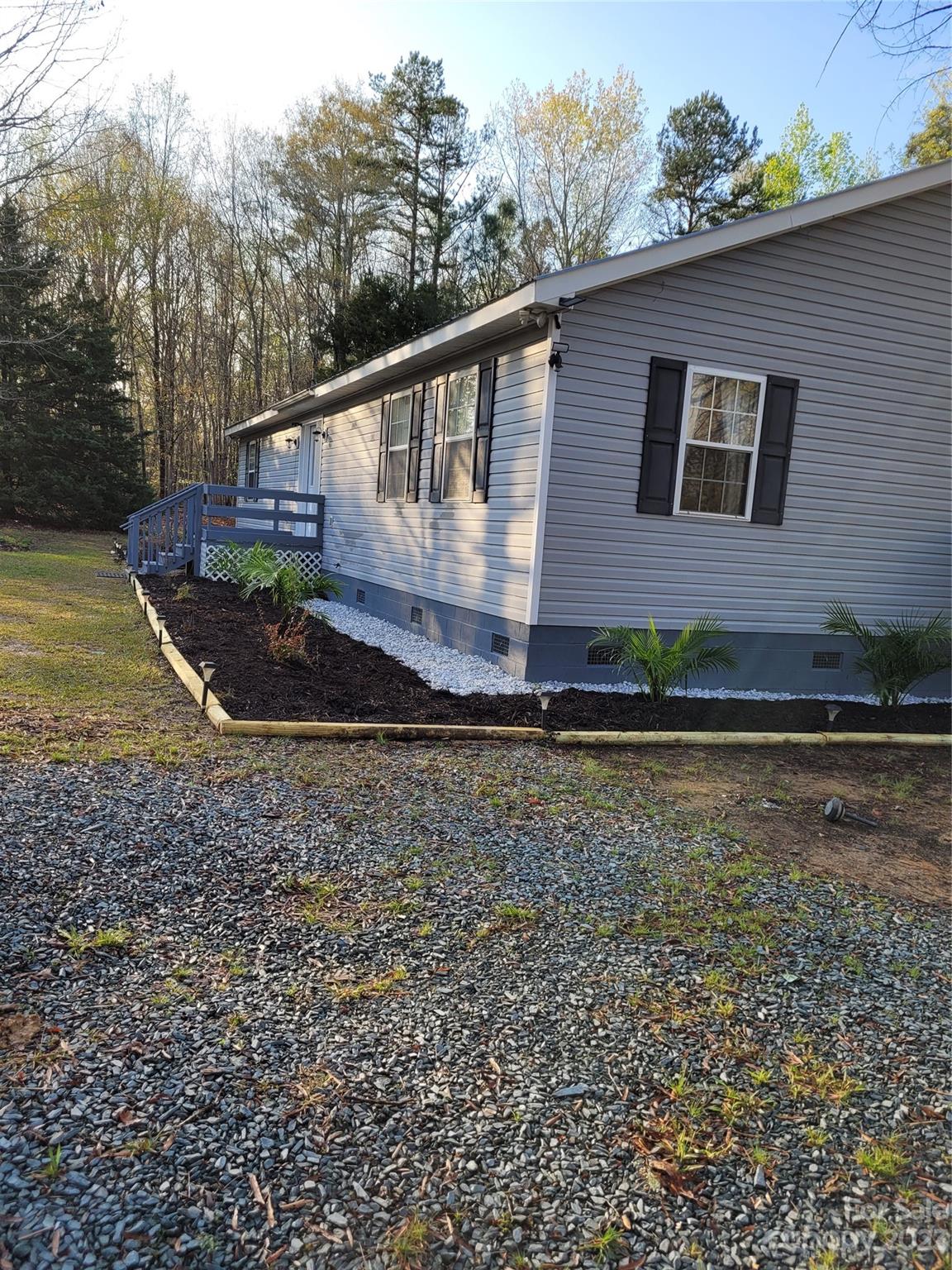 8705 Simpson Road Waxhaw, NC 28173 - Photo 3 of 46 a view of a house with a yard