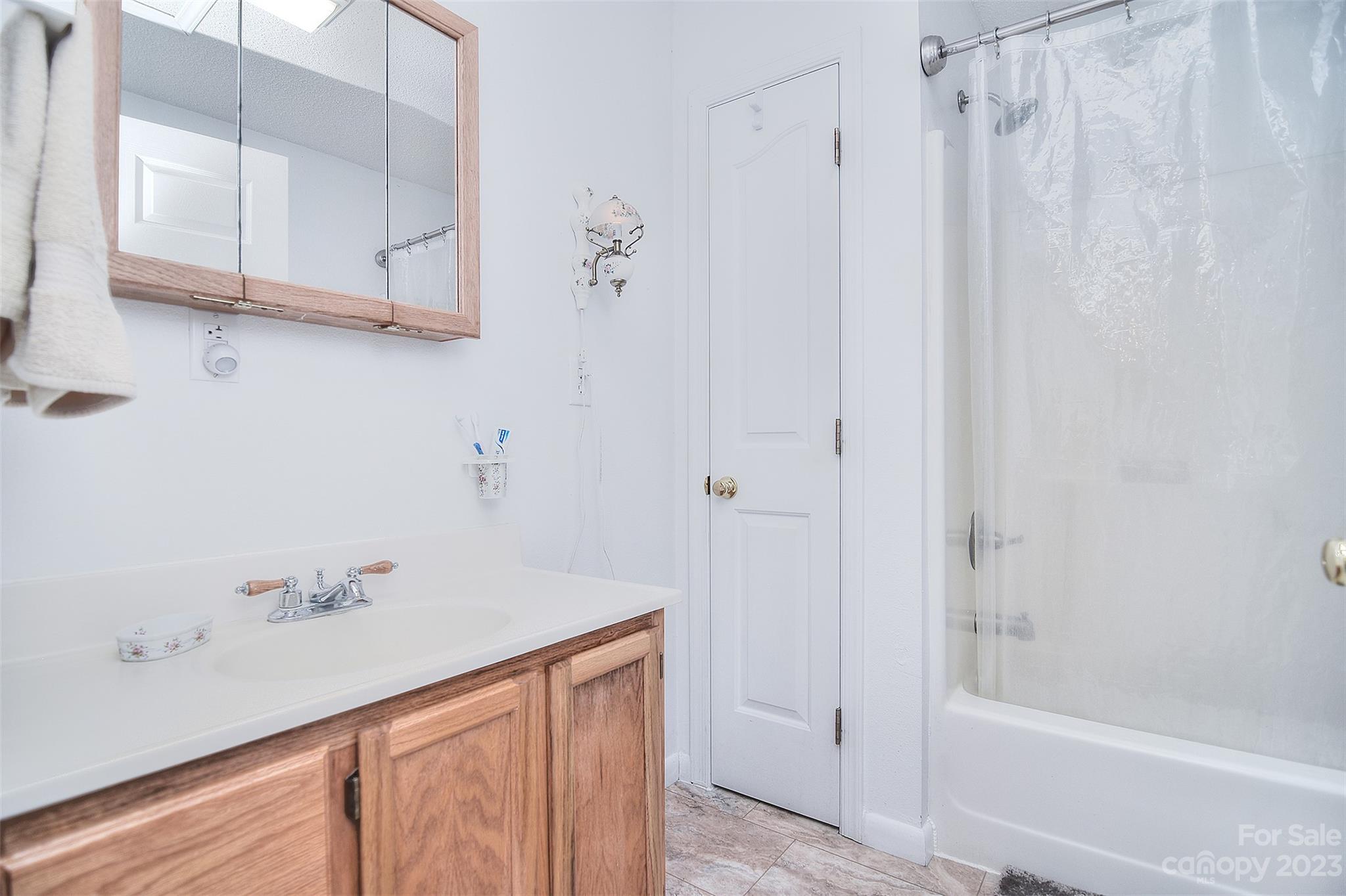 8705 Simpson Road Waxhaw, NC 28173 - Photo 31 of 46 a bathroom with a shower and a sink