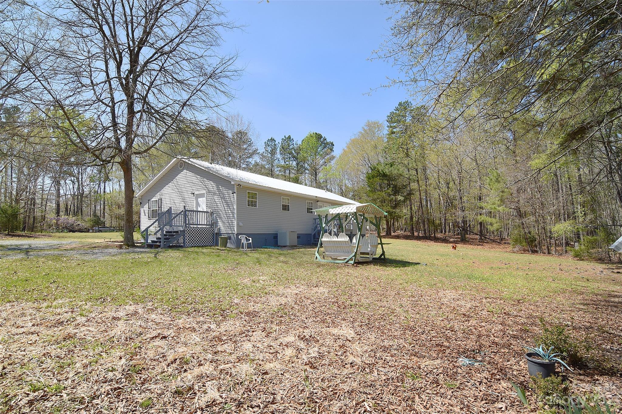 8705 Simpson Road Waxhaw, NC 28173 - Photo 38 of 46 a house with a big yard and large trees