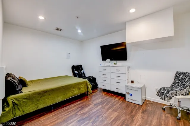 a bedroom with furniture and a flat screen tv