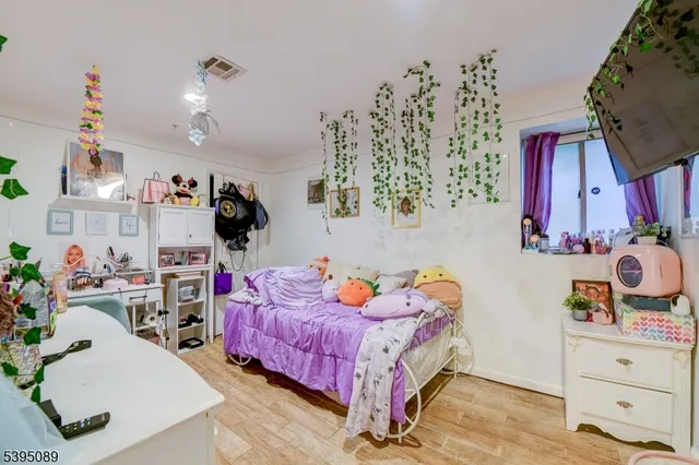 a bedroom with bed and the view of bathroom