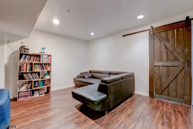a living room with furniture and a book shelf