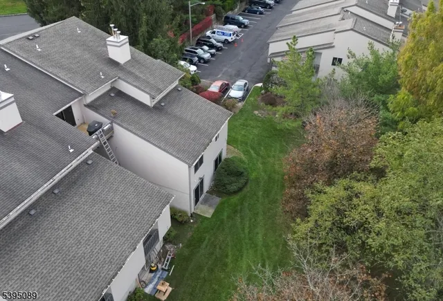 an aerial view of multiple houses with yard