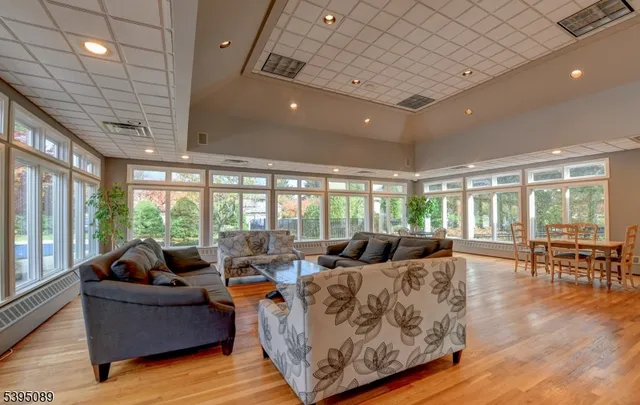 a living room with furniture and large windows