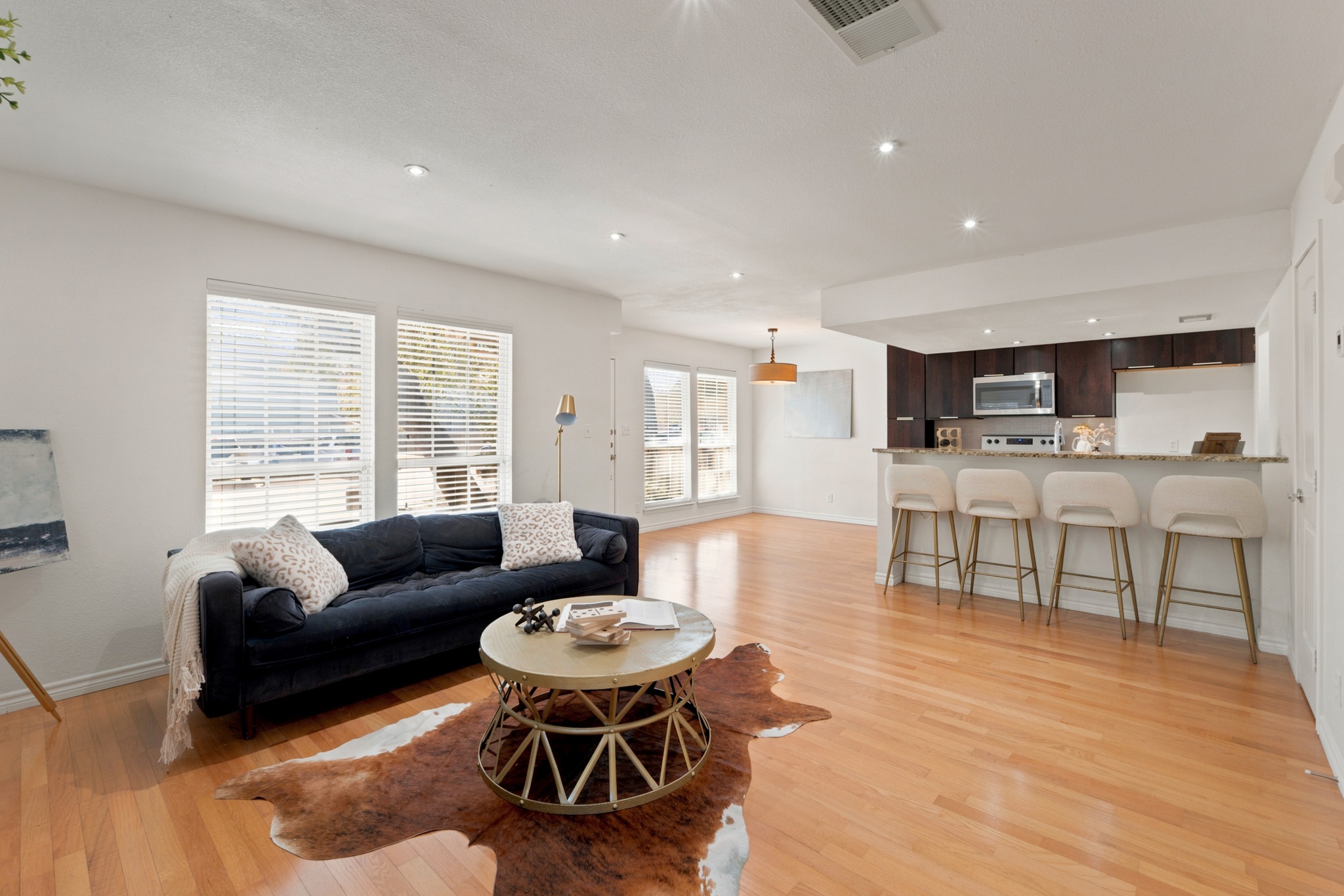 1504 Allen Road, Unit B Austin, TX 78746 - Photo 7 of 24 Gleaming hardwood floors run through this open-concept main living area and integrated kitchen space.