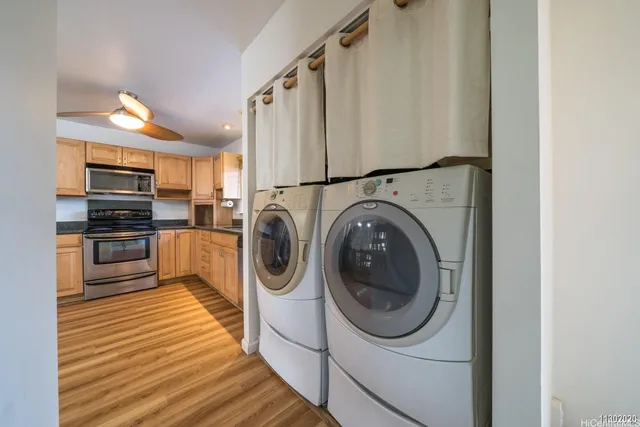 a kitchen with stainless steel appliances granite countertop a refrigerator and a stove top oven
