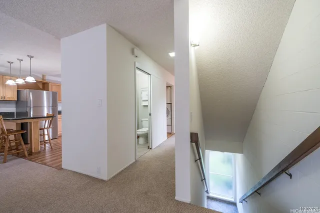 a view of a hallway with a kitchen