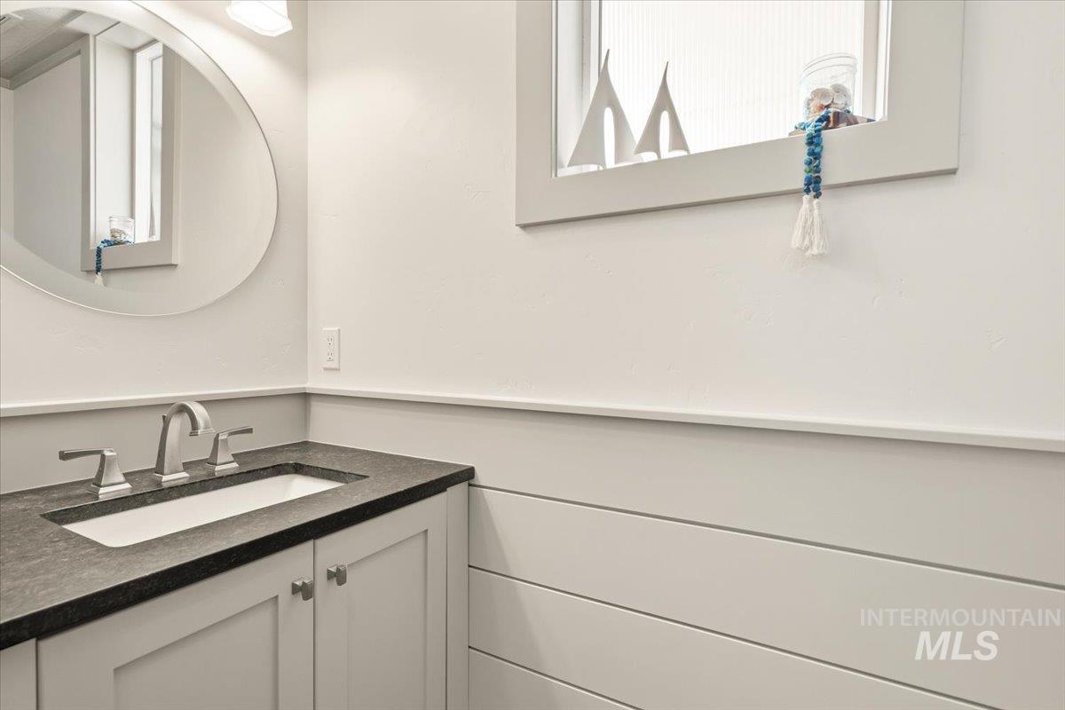 3794 South Single Tree Avenue Boise, ID 83716 - Photo 24 of 50 Vanity with integrated sink and dark countertop