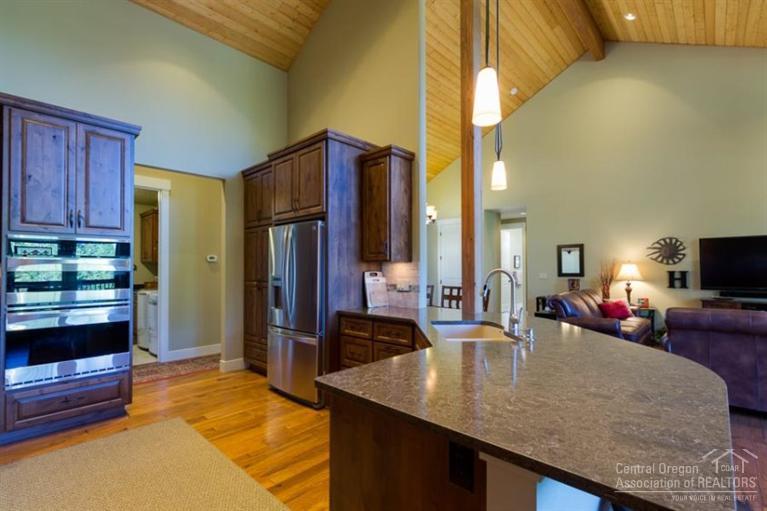 22 Oregon Loop Sunriver, OR 97707 - Photo 9 of 25 a kitchen with sink refrigerator and cabinets