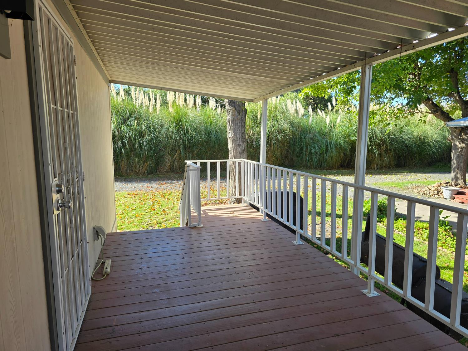 13955 West Walnut Grove Road, Unit 26 Walnut Grove, CA 95690 - Photo 5 of 31 a view of porch with wooden floor and outdoor seating