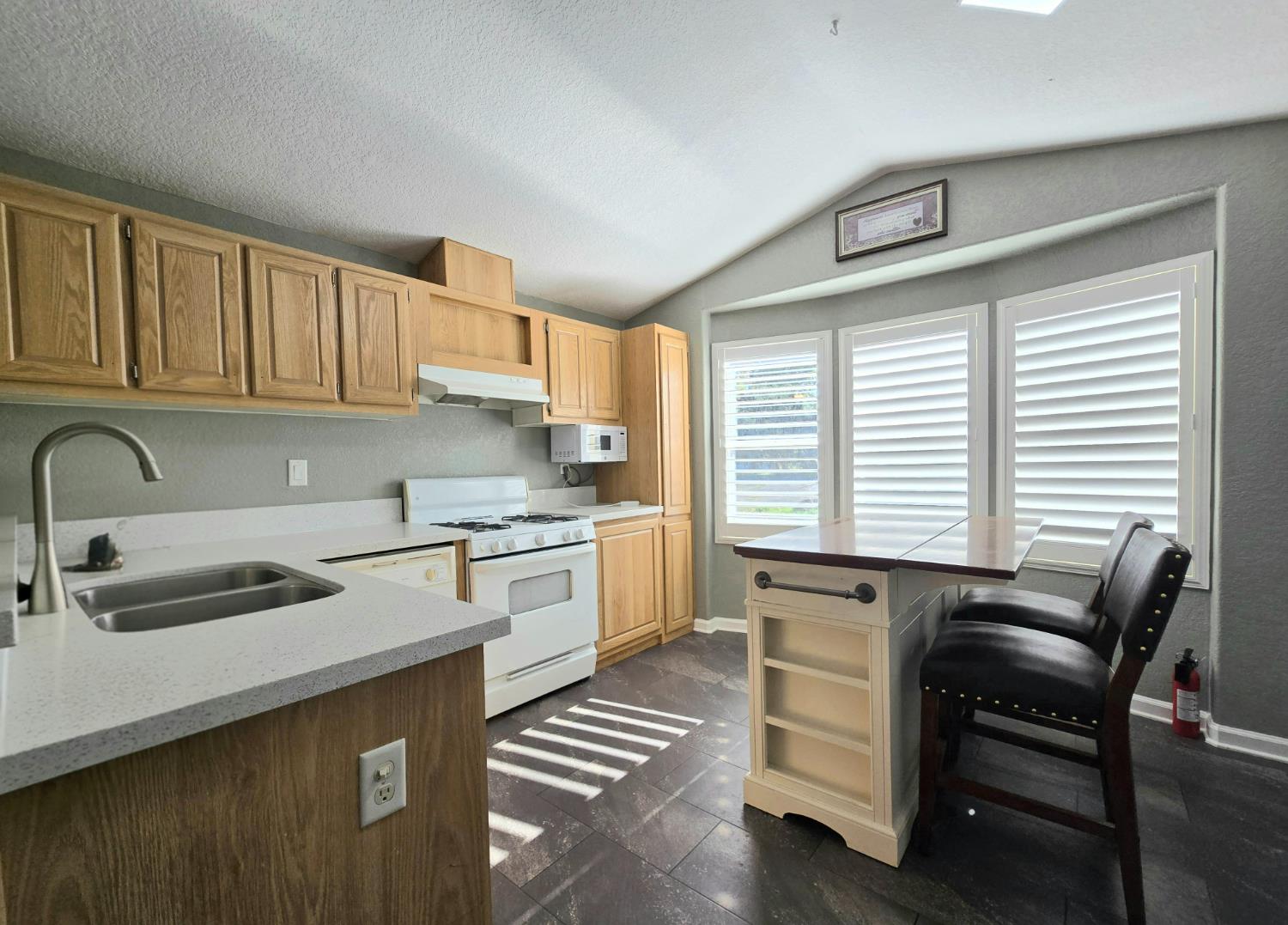 13955 West Walnut Grove Road, Unit 26 Walnut Grove, CA 95690 - Photo 6 of 31 a kitchen that has a sink a stove and cabinets