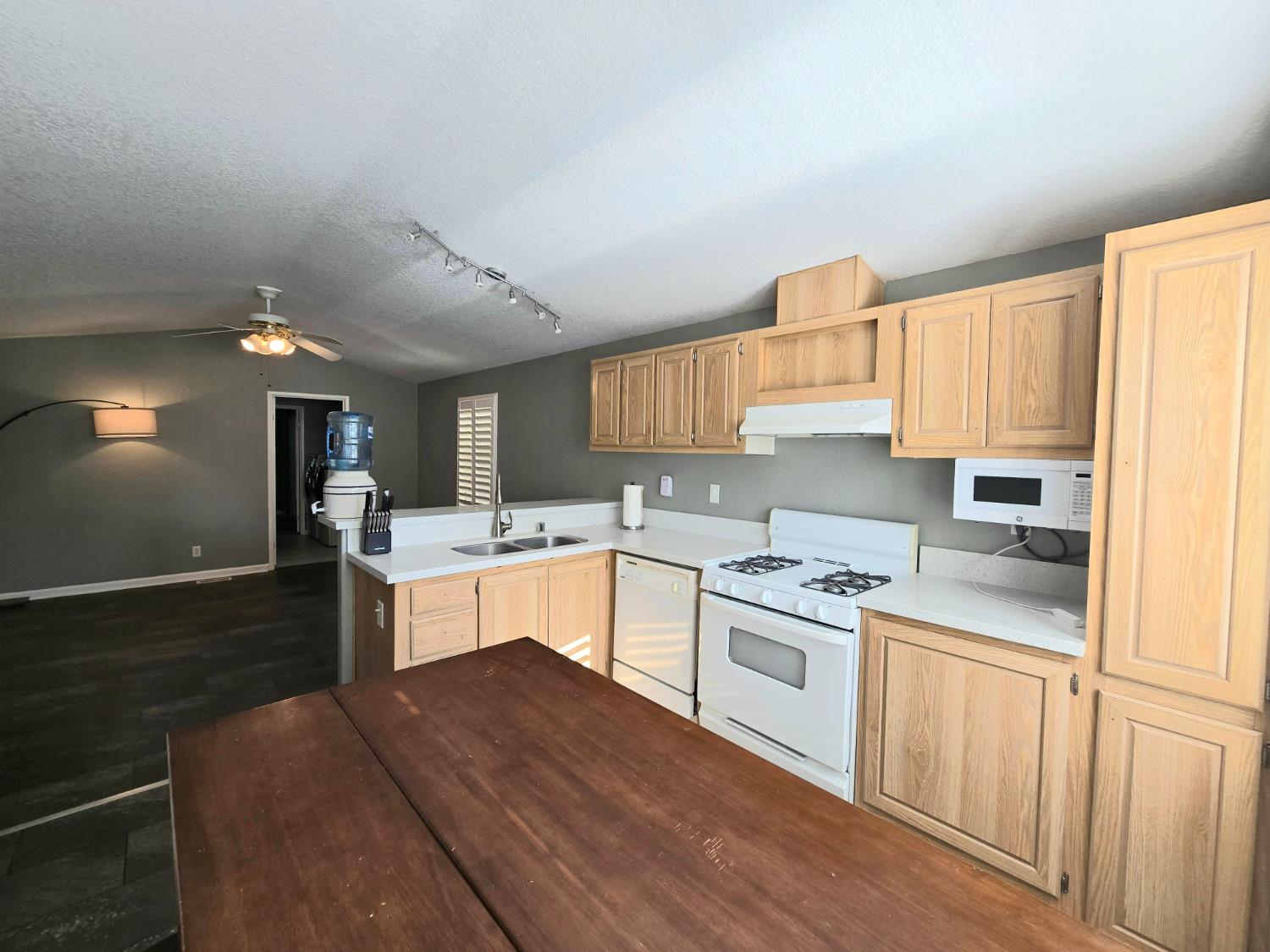 13955 West Walnut Grove Road, Unit 26 Walnut Grove, CA 95690 - Photo 8 of 31 a kitchen with a sink cabinets and wooden floor