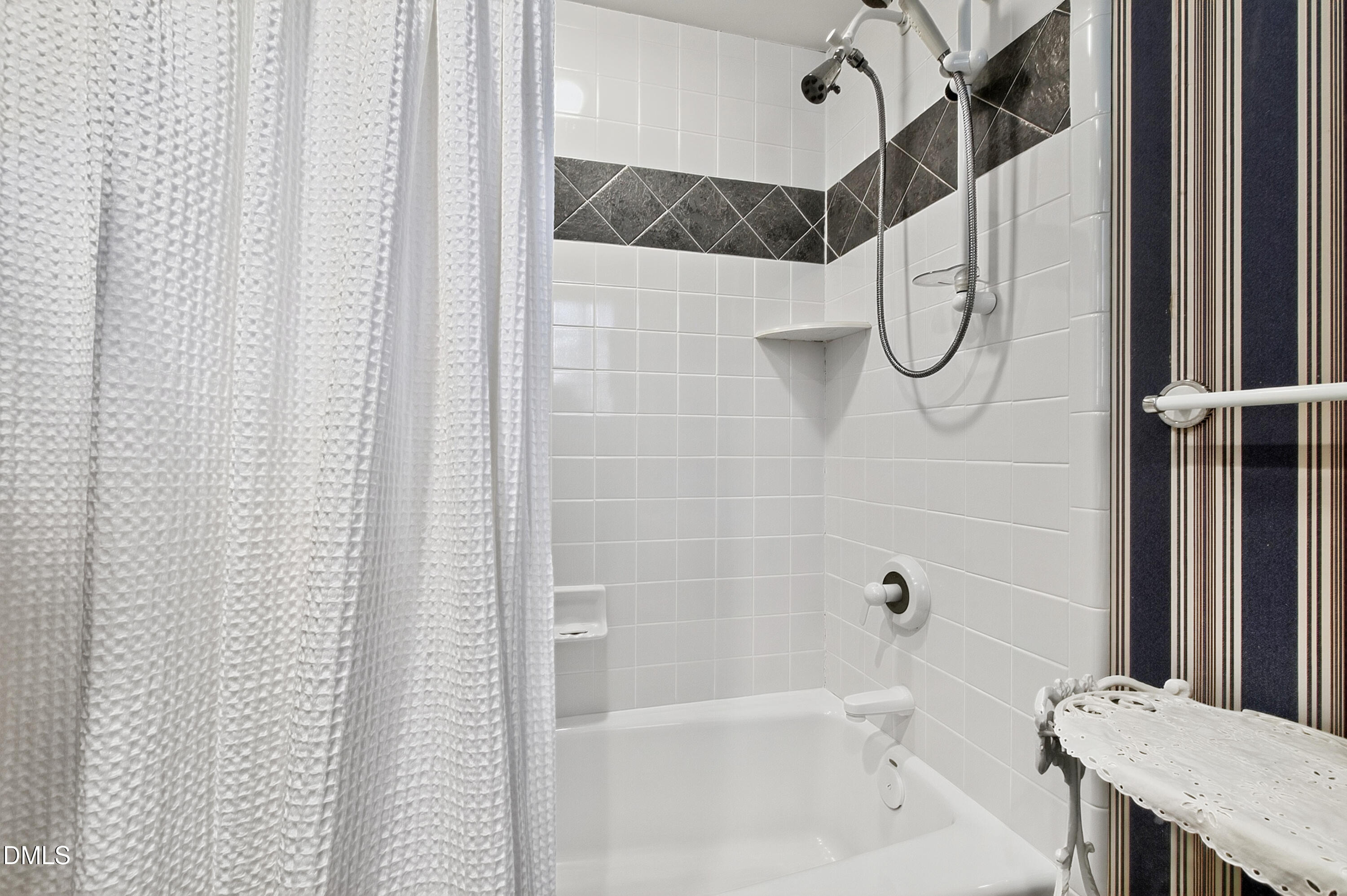 3708 Lubbock Drive Raleigh, NC 27612 - Photo 48 of 64 a bathroom with a shower curtain and a bathtub