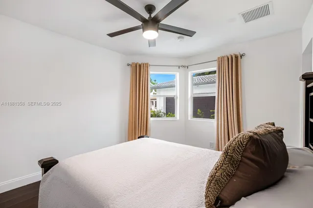 a bedroom with a large bed and a chandelier