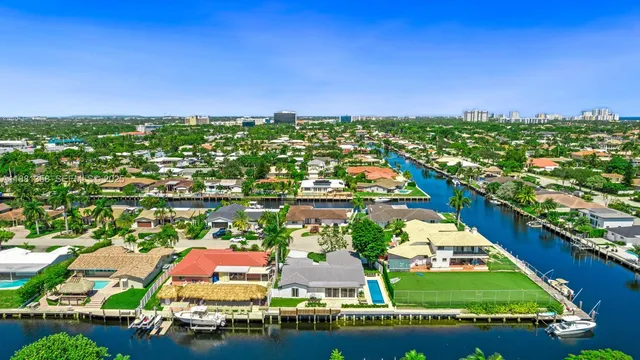 a front view of a house with a garden and tree
