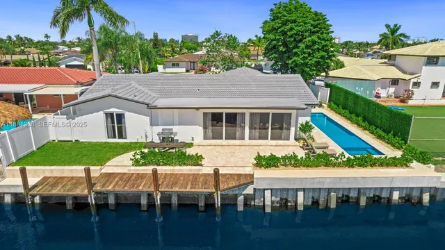 a aerial view of a house with a yard slide and outdoor seating