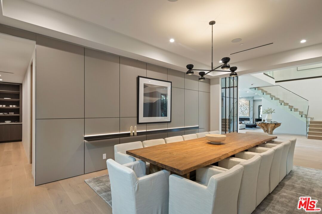 17055 Rancho Street Encino, CA 91316 - Photo 27 of 73 a bedroom with a bed and a chandelier
