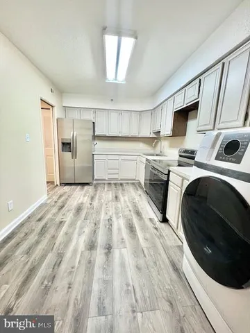 a kitchen with a sink a stove and cabinets