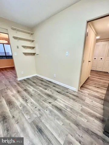 a view of a room with wooden floor and white walls