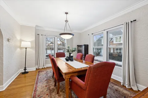 a view of a dining room with furniture window and wooden floor