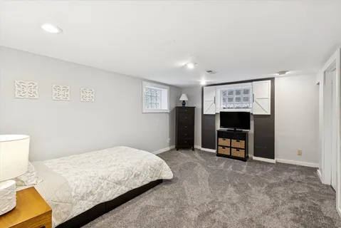 a bedroom with a bed a table and a television