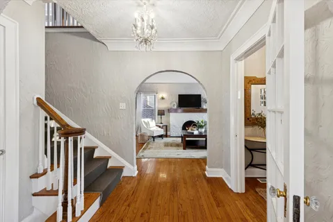 a view of a livingroom with wooden floor and furniture