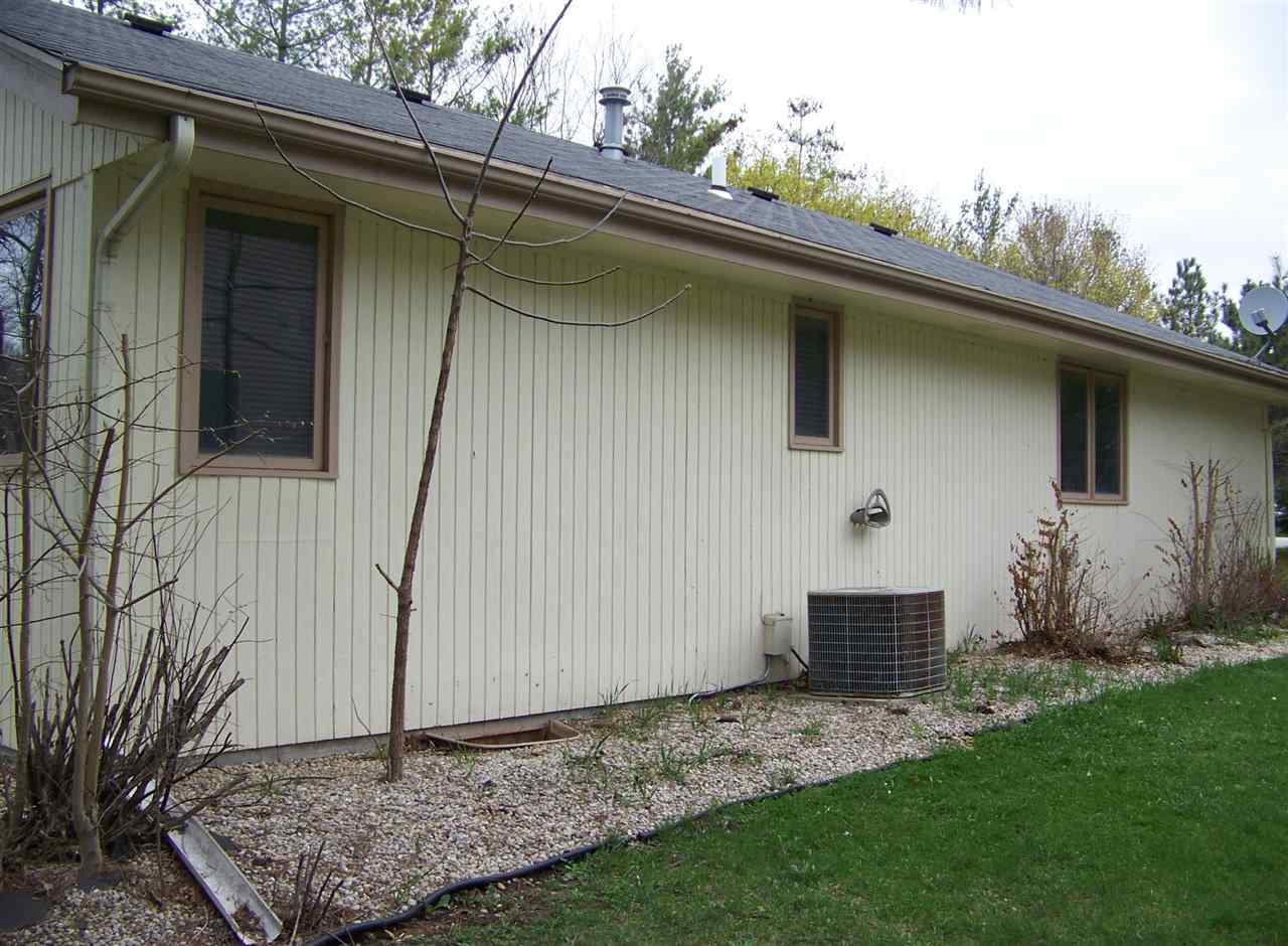 11928 Bend River Road Roscoe, IL 61073 - Photo 4 of 17 a backyard of a house with plants and barbeque oven