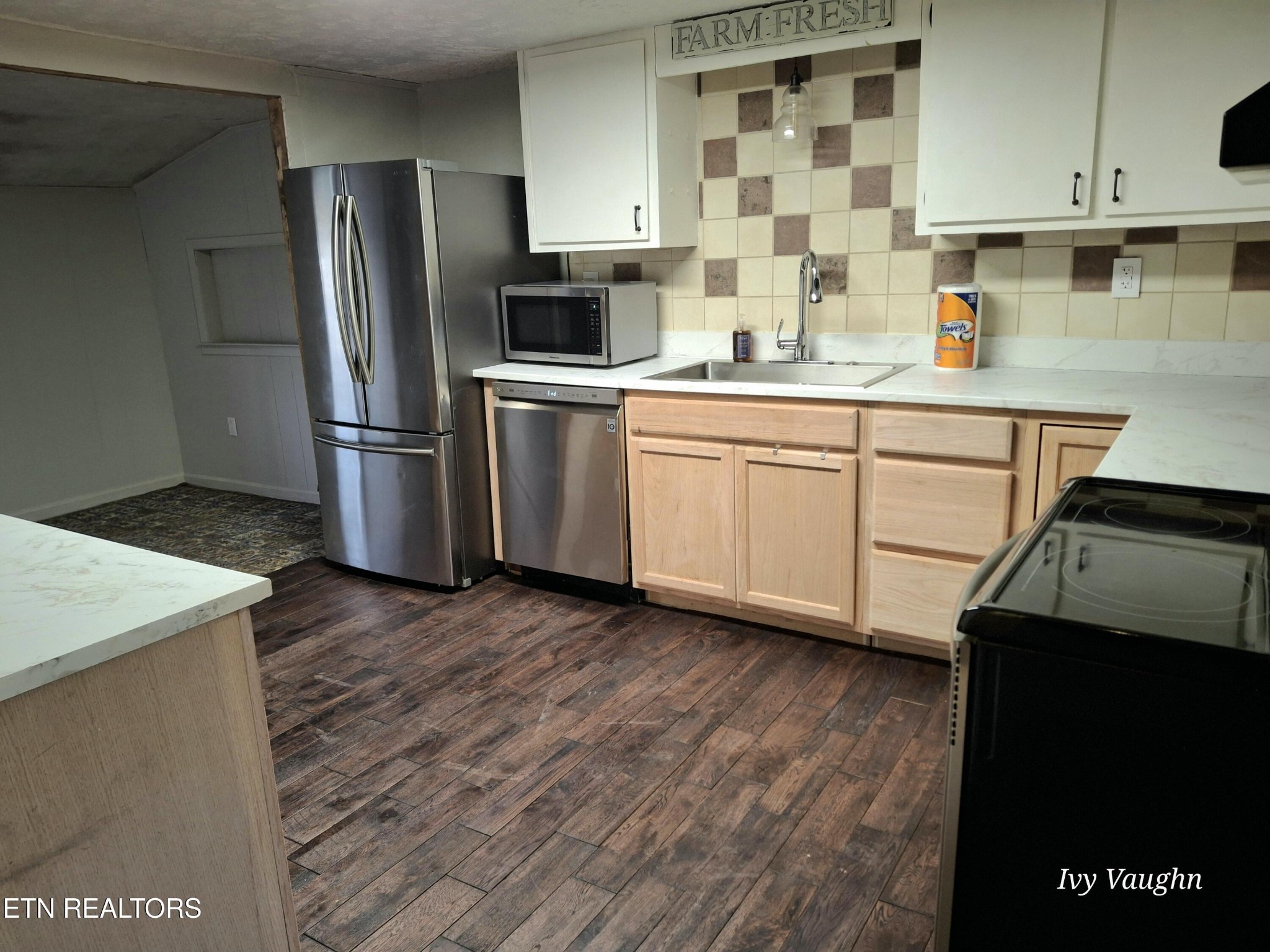 893 Brushy Valley Road Heiskell, TN 37754 - Photo 11 of 28 a kitchen with a sink dishwasher a refrigerator and cabinets with wooden floor