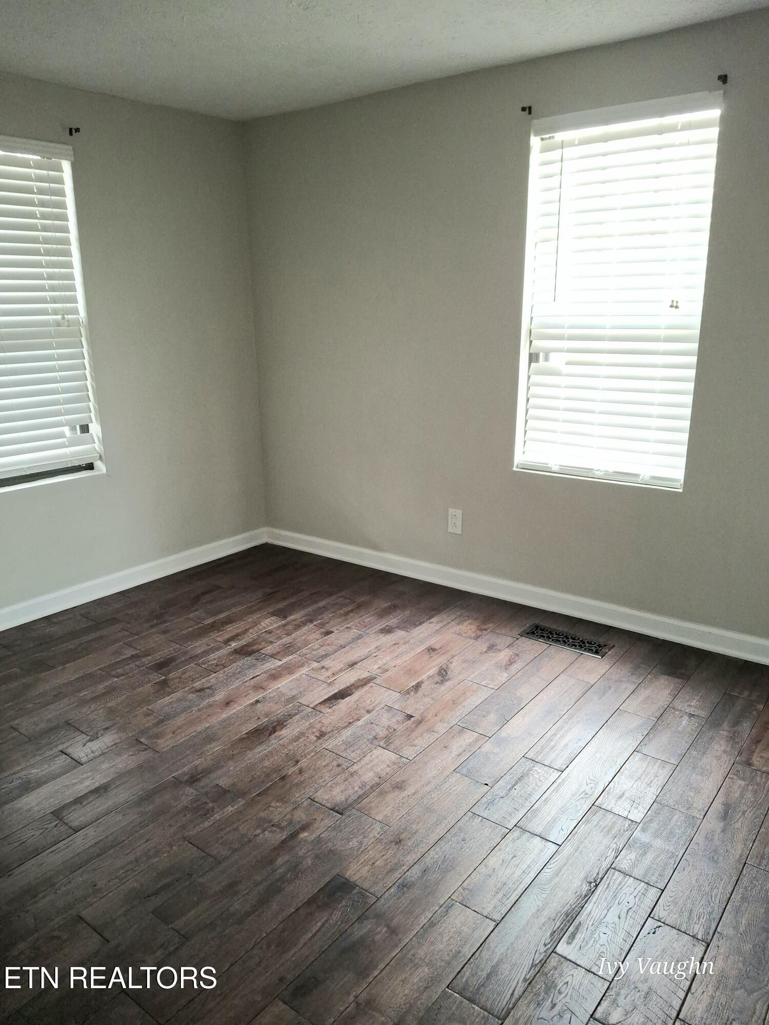 893 Brushy Valley Road Heiskell, TN 37754 - Photo 17 of 28 an empty room with wooden floor and windows