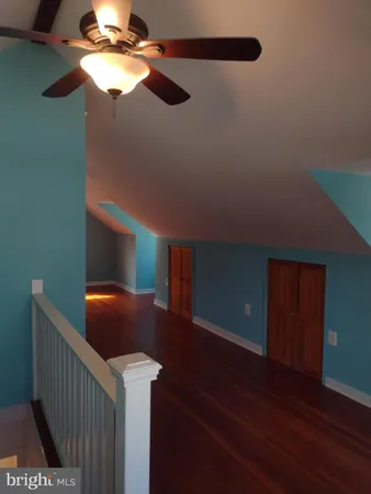 a room with furniture and a chandelier fan