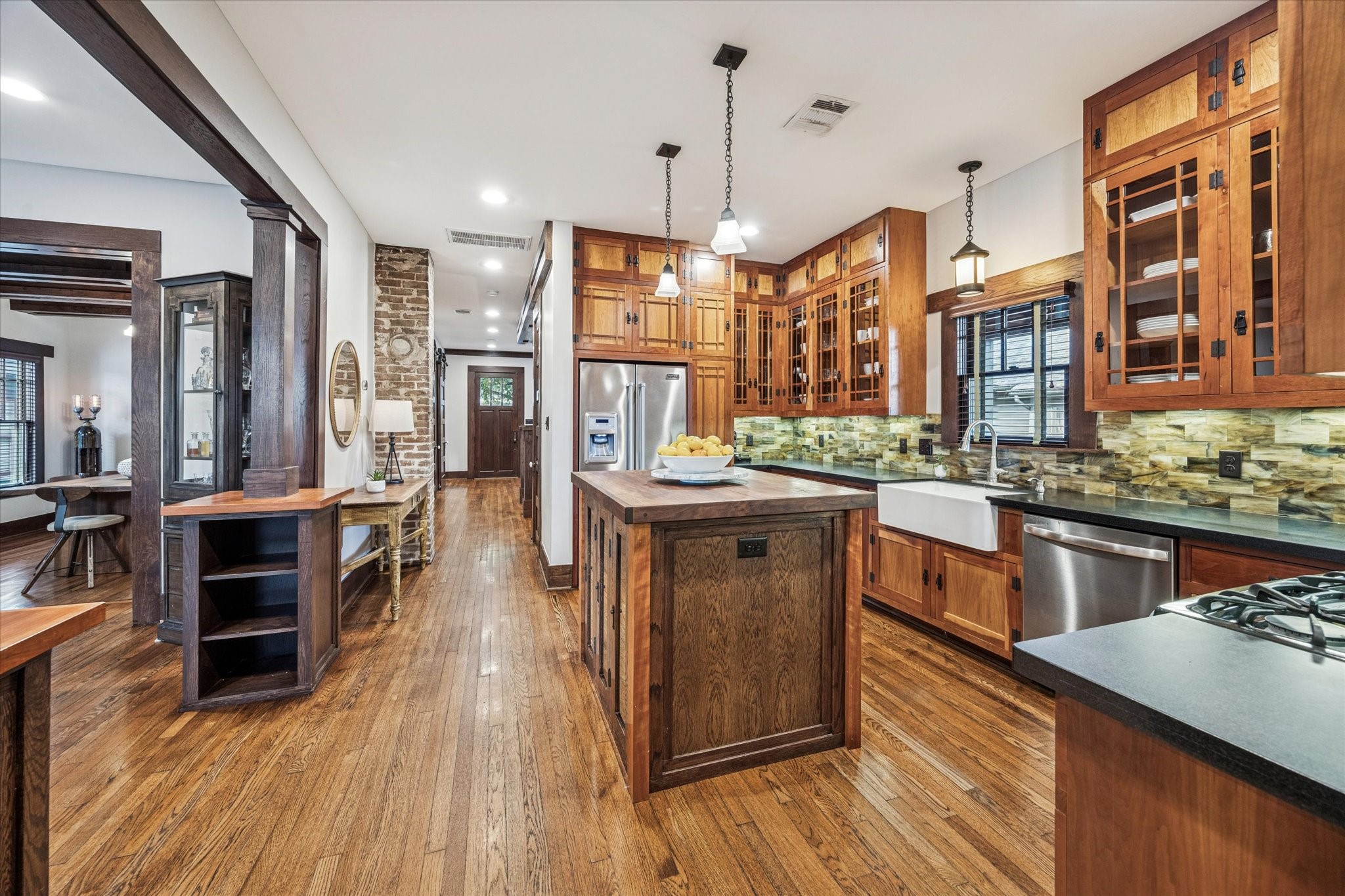 512 Archer Street Houston, TX 77009 - Photo 3 of 40 Stunning kitchen with custom hand-crafted hardwood cabinets made of cherry wood, oak and walnut trim and honed granite countertops.