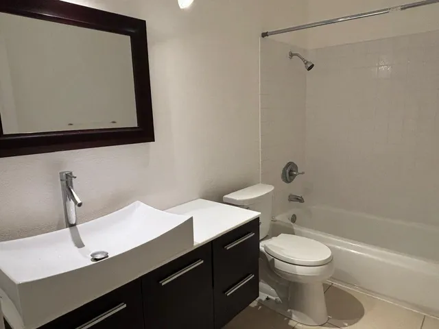 a bathroom with a double vanity sink and mirror
