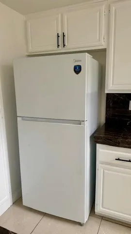 a kitchen with granite countertop a stove sink and cabinets