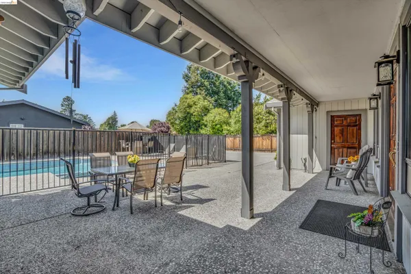 a kitchen with stainless steel appliances kitchen island granite countertop a refrigerator and a sink