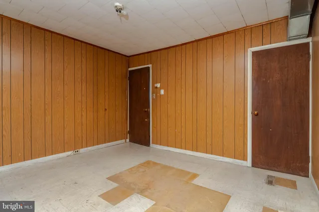 a view of an empty room with wooden walls