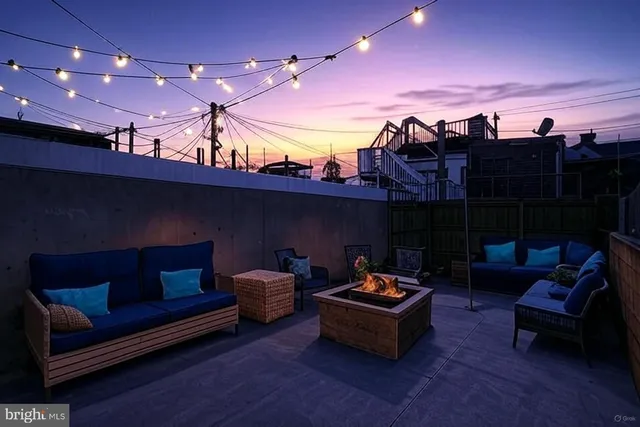 a outdoor living space with furniture and a fireplace