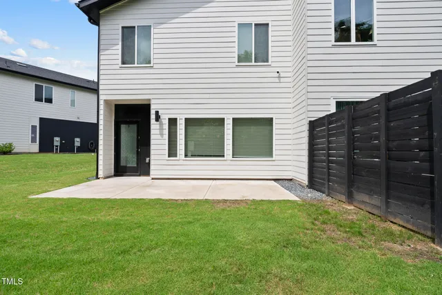 a view of an house with backyard and porch