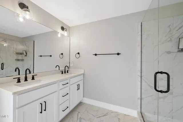 a bathroom with a double vanity sink and a mirror