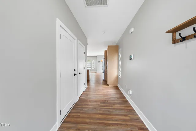 a view of a hallway with wooden floor