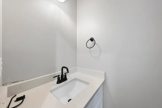 a bathroom with a sink and mirror