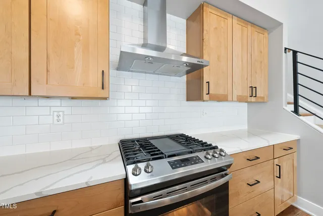 a kitchen with granite countertop a stove and a sink